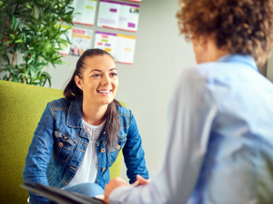 Young woman in a counselling session smiling at the therapist