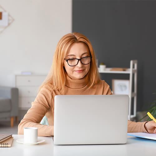 Counsellor sitting at her computer working on her brand for her private practice